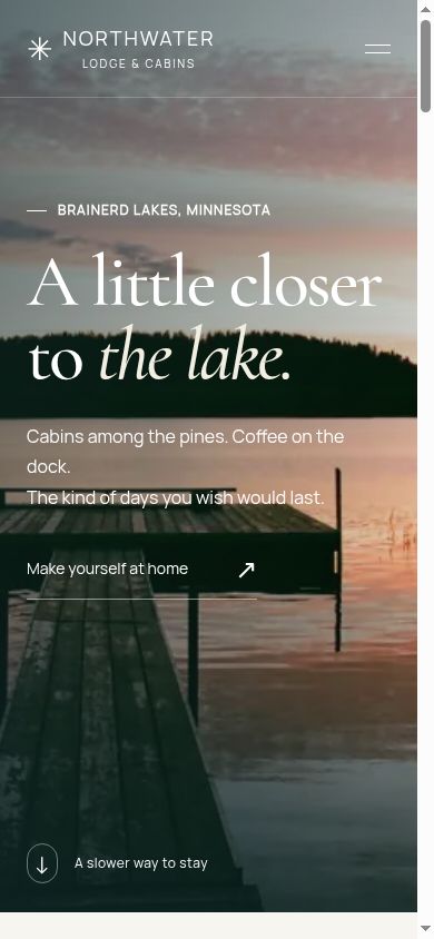 The homepage at a 390px responsive width. The lake photograph and main heading stay prominent, with navigation behind a compact menu.