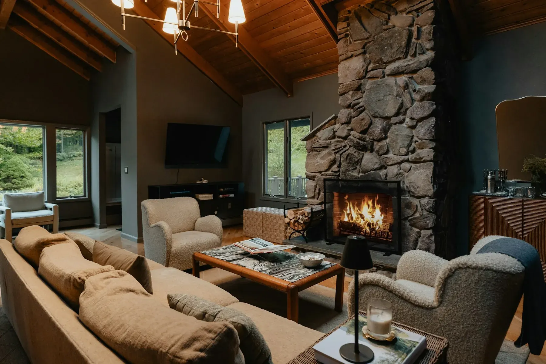 A comfortable lodge lounge with a stone fireplace